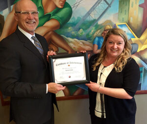 Al Gerhardt presents LDP certificate to Project Manager Rachael Oelke