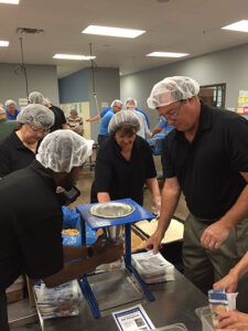 Volunteers pack nutritious meals at Feed My Starving Children