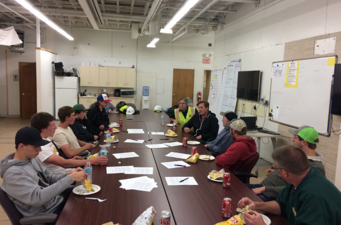 People sitting at a table in a jobsite office