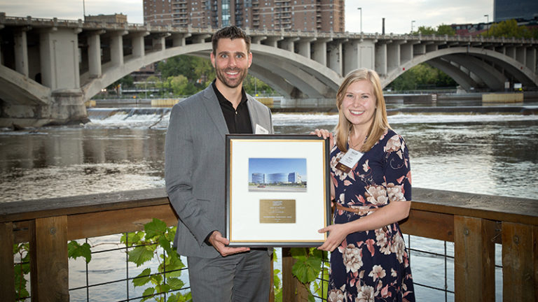 Architect and contractor with award plaque