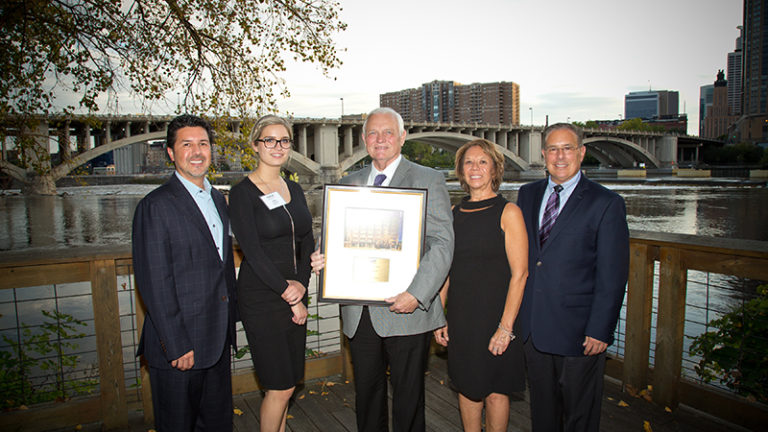Group holding award plaque