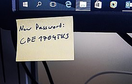 password written on a post it note on a computer