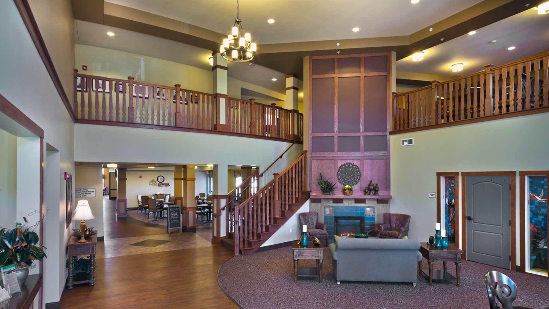 Engel Haus Senior Housing Interior Two Story Lobby Seating Area with Fireplace