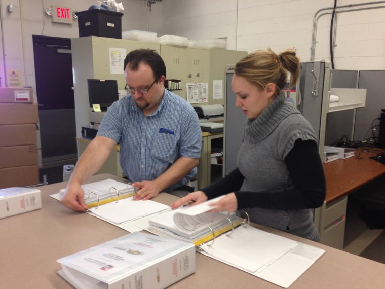 Jake O'Connor and Krystal Burton working on job closeouts. Autism Awareness