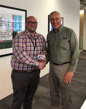 Bob Janssen receives the KA Core Values Award from Director of Operations Craig Francois