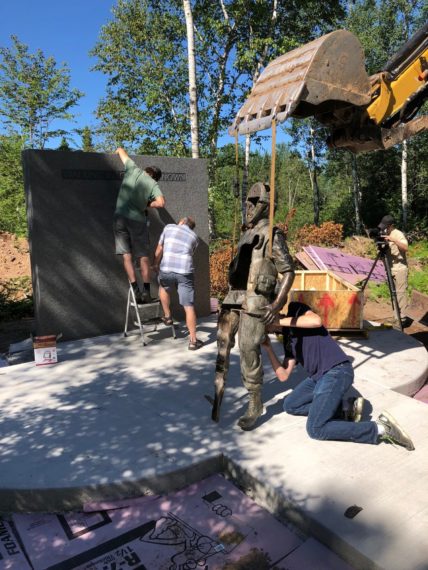 Installing the sculpture for the Agent Orange- Walking into the Unknown Monument