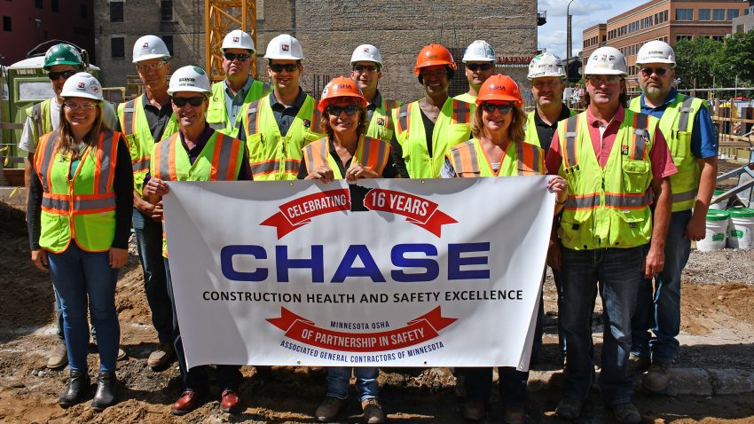 Diverse project team with OSHA CHASE Safety banner