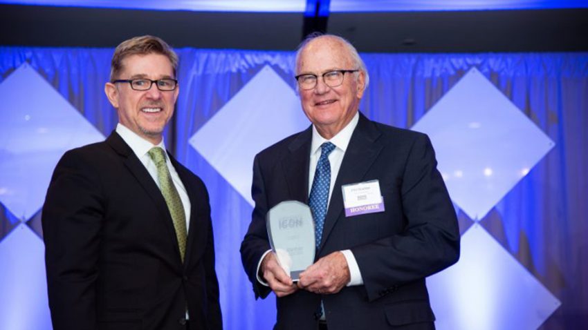 Bill Gaier, president and publisher, Finance & Commerce, presents the ICONS award to Phil Boelter