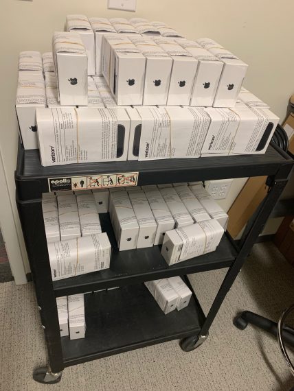 cart filled with iPhones in their boxes