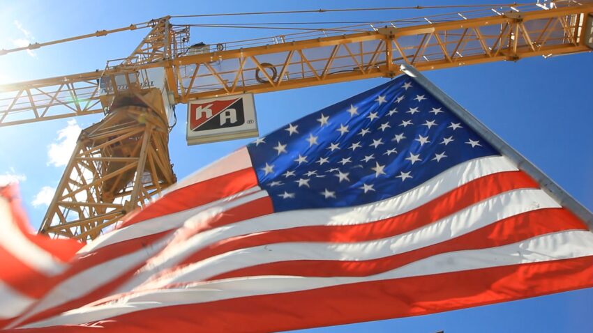 American flag flying by a KA crane