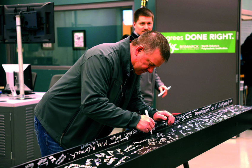 Ross Wilmes signing the beam at BSC Polytechnic Center topping off