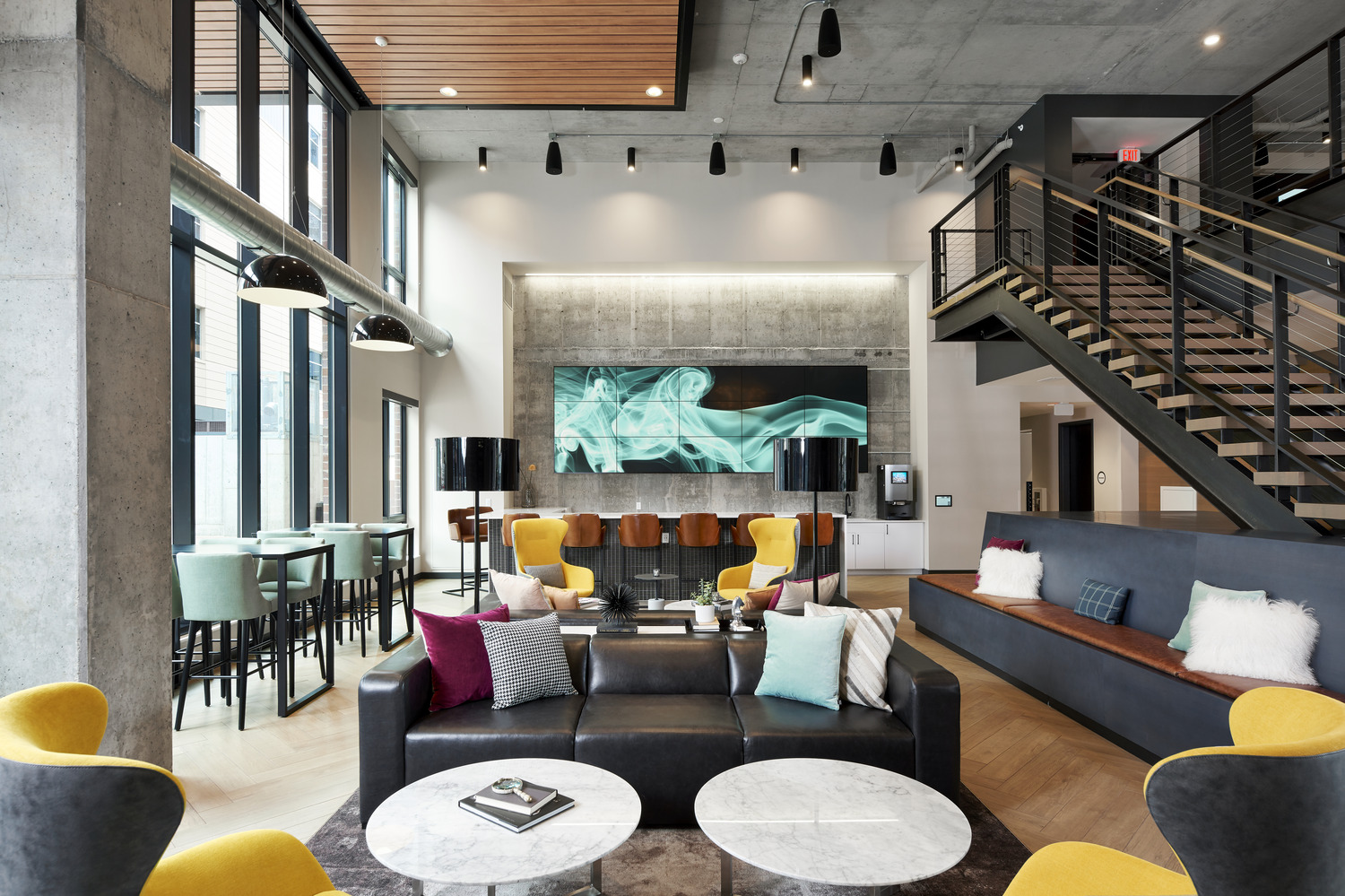 New 17-story residential tower located at Portland Ave. at 9th Street in downtown Minneapolis. 306-unit apartment residence has been named “H.Q.” Owned by Kraus-Anderson, H.Q. is part of the new comprehensive, mixed-use block development that also features Kraus-Anderson’s new home office, a 160-room hotel and Finnegan’s microbrewery. Designed by Elness Swenson Graham (ESG) Architects Inc., the apartment tower’s signature design reflects the excitement of the developing urban community of East Town. H.Q. has a brick masonry base on levels 1-9 that relates to the brick and stone context found throughout historic Elliott Park. Levels 10-17 are clad in a contemporary, high quality aluminum composite metal panel and the upper floors cant out at an angle to create a signature look. Street level walk-out units provide front porches with eyes on the street along Portland Avenue. Metal clad bays also provide articulation along the building façade. Inside, the highly transparent, two story lobby will include a lounge with a bar and many seating areas, allowing residents to meet visitors or their neighbors for informal get-togethers or planned social events. A second-floor seating section, TV area and meeting space overlook the first-floor lobby lounge. A generous fitness facility faces the courtyard and activates the west side of the first floor. The ninth floor hosts several other discrete “hang out” spaces, including a full demonstration kitchen and bar, multiple TV and game areas. The outdoor terrace will be home to a large social spa, several lounging and seating areas, and a cooking section, all with outstanding downtown and stadium views. Property management will be provided by Saturday Properties, based in Minneapolis.