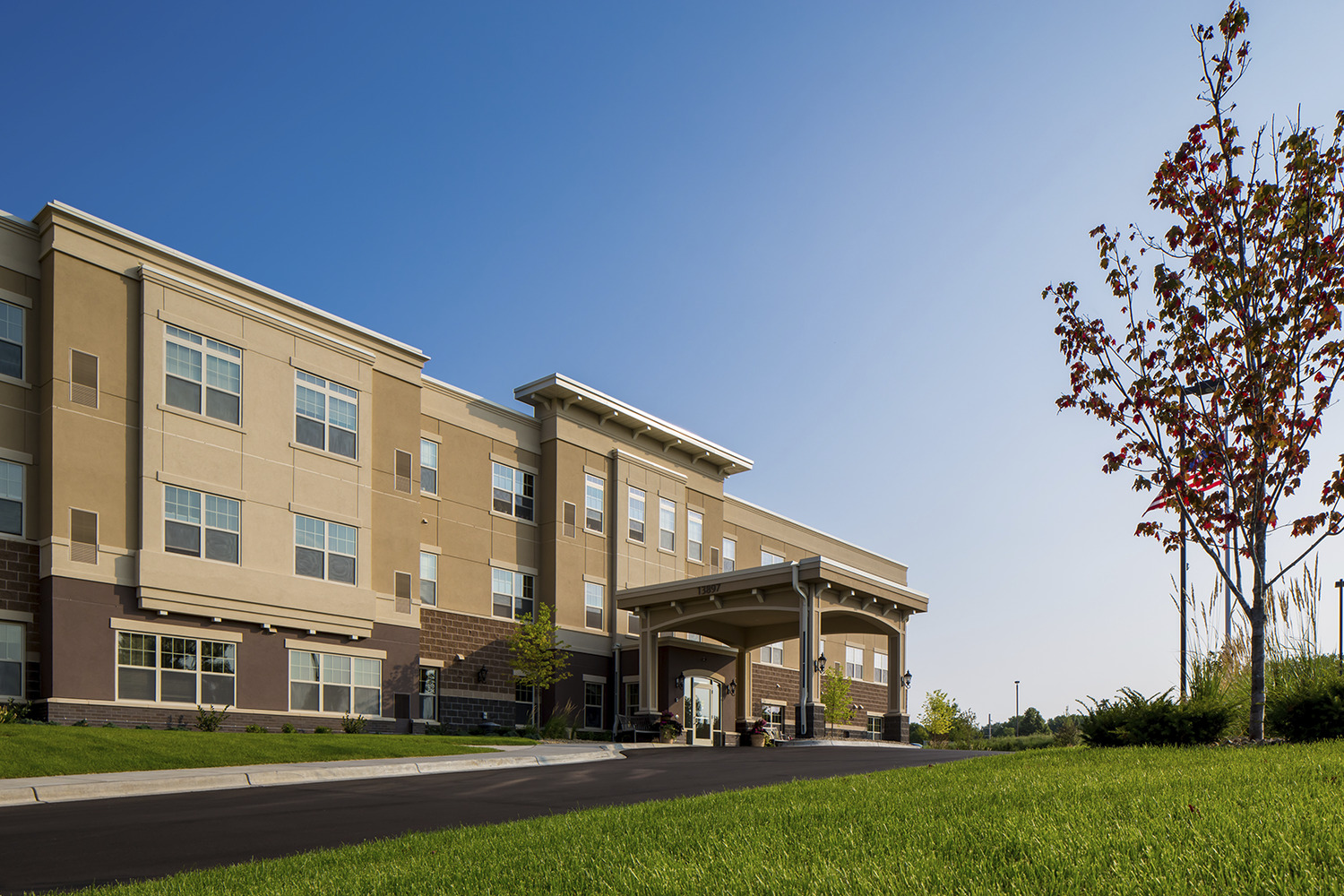 "Arbors II Assisted Living, located in Burnsville and owned by Ebenezer Management Services, is a $12 million, 63-unit Assisted Living building on the Arbors at Ridges campus in Burnsville. The addition to the campus of Arbors II Assisted Living enables Ebenezer to convert an existing building on the campus to Memory Care space. Arbors II Assisted Living brings 63 assisted living units to the five-acre campus at 13897 Community Drive near Fairview Ridges Hospital. Since the completion of Arbors II, residents at an existing 44-unit assisted living building
on the Arbors campus will move in and the older space will be converted to much-needed memory care units. Arbors II Assisted Living includes patios, gardens, a four-season porch, walking paths, a movie theater, library, beauty and barber shop, physical therapy space, a clubroom, dining rooms, chapel, coffee shop, gift shop and lounges. Units at Arbors II include a guest apartment and six “care suites” for post-operative and therapy residents. Jim Beckwith – Project Manager. Sperides Reiners Architects."