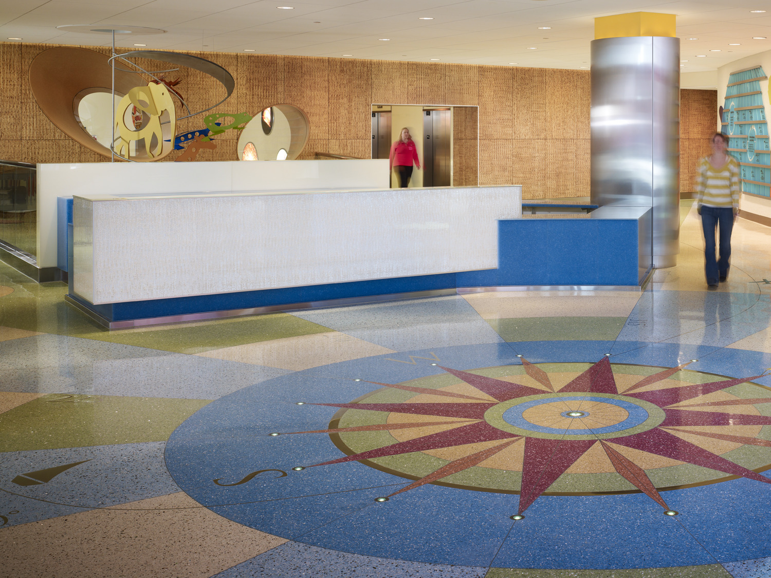 "Kraus-Anderson has completed this large healthcare project that involves construction of a new 6-story, 96-bed patient tower plus penthouse (230,000 s.f.); OR/ED expansion (30,000 s.f.); existing space renovation (50,000 s.f.); and 3 stories of underground parking for 180 cars. The 7-story Amplatz Children’s Hospital patient tower includes kidney dialysis, a pediatric intensive care unit, a floor for bone marrow transplants, general patient rooms, linear accelerator, sedation rooms, support services, a coffee shop, a gift shop and a mechanical penthouse. A new linking structure has been built between the campus’s existing East Building and the new Amplatz Children’s Hospital. The link contains new OR and ED Departments as well as a Doctor’s Lounge. The new OR Department is aimed primarily at children and contains six new Operating Rooms. Four of them will be utilized right away; the other two are shelled out for future use. Each OR has a different function including one for head injuries and one for neurosurgery. The department also has a large sterile supply area and a sterilization room. The ED Department will serve both children and adults. There is a walk-in Emergency Entrance, and an Ambulance Entrance. There is also a triage room. The ambulance garage has a break room for EMT Technicians, an MRI room, and a Decontamination Room with showers for victims of exposure to radiation or hazardous chemical spills. The water from these showers goes into a special disposal tank. The ER patient area features a long admitting area desk and four types of private emergency treatment rooms.  There is a special psychiatric lock-up room, trauma rooms for the most pressing cases, isolation rooms for people admitted with infectious diseases such as tuberculosis, and regular emergency treatment rooms. The 50,000 s.f. remodeling of a portion of the existing East Building involves a complete renovation of radiology, cardiovascular services, and PACU Pre/Post Services."