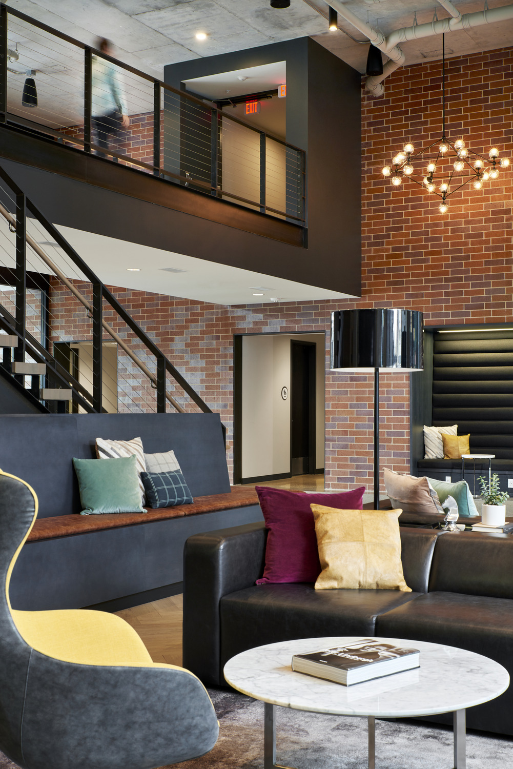 New 17-story residential tower located at Portland Ave. at 9th Street in downtown Minneapolis. 306-unit apartment residence has been named “H.Q.” Owned by Kraus-Anderson, H.Q. is part of the new comprehensive, mixed-use block development that also features Kraus-Anderson’s new home office, a 160-room hotel and Finnegan’s microbrewery. Designed by Elness Swenson Graham (ESG) Architects Inc., the apartment tower’s signature design reflects the excitement of the developing urban community of East Town. H.Q. has a brick masonry base on levels 1-9 that relates to the brick and stone context found throughout historic Elliott Park. Levels 10-17 are clad in a contemporary, high quality aluminum composite metal panel and the upper floors cant out at an angle to create a signature look. Street level walk-out units provide front porches with eyes on the street along Portland Avenue. Metal clad bays also provide articulation along the building façade. Inside, the highly transparent, two story lobby will include a lounge with a bar and many seating areas, allowing residents to meet visitors or their neighbors for informal get-togethers or planned social events. A second-floor seating section, TV area and meeting space overlook the first-floor lobby lounge. A generous fitness facility faces the courtyard and activates the west side of the first floor. The ninth floor hosts several other discrete “hang out” spaces, including a full demonstration kitchen and bar, multiple TV and game areas. The outdoor terrace will be home to a large social spa, several lounging and seating areas, and a cooking section, all with outstanding downtown and stadium views. Property management will be provided by Saturday Properties, based in Minneapolis.