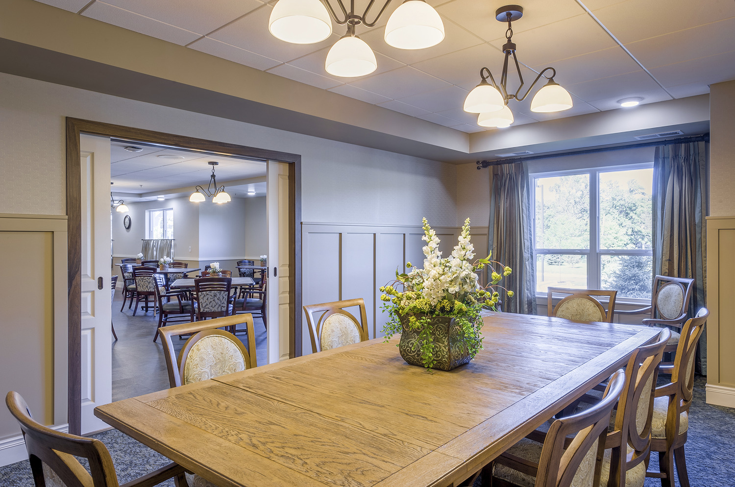 "Deephaven Woods Senior Living, a new senior living community located on the campus of The Church of St. Therese in Deephaven, Minn., has been recently completed. St. Therese Catholic Church partnered with Ebenezer Society to form St. Therese Senior Living, LLC, the joint venture that built Deephaven Woods. Deephaven Woods Senior Living fulfills the Church of St. Therese’s desire to further its mission by providing a housing option to the region’s growing senior population. The new senior living community is located on a 14-acre site, part of the church’s 26-acre campus. The two-story development consists of 78 units of independent, assisted living, memory care and Care Suite apartments, and is enhanced by on site amenities including a chapel, heated underground parking garage, an expansive two-story lobby, and outdoor patios, porches, gardens and walking paths. Deephaven Woods Senior Living offers everything seniors need for active, carefree senior living today, with the assurance of care for the future."