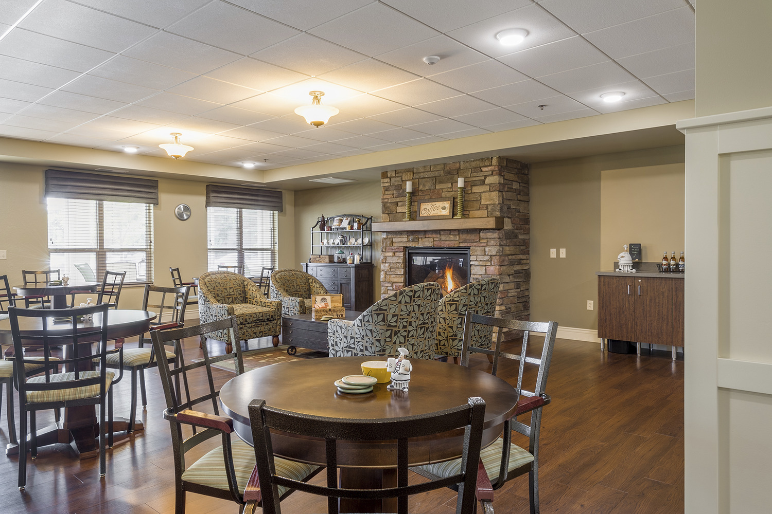 "Deephaven Woods Senior Living, a new senior living community located on the campus of The Church of St. Therese in Deephaven, Minn., has been recently completed. St. Therese Catholic Church partnered with Ebenezer Society to form St. Therese Senior Living, LLC, the joint venture that built Deephaven Woods. Deephaven Woods Senior Living fulfills the Church of St. Therese’s desire to further its mission by providing a housing option to the region’s growing senior population. The new senior living community is located on a 14-acre site, part of the church’s 26-acre campus. The two-story development consists of 78 units of independent, assisted living, memory care and Care Suite apartments, and is enhanced by on site amenities including a chapel, heated underground parking garage, an expansive two-story lobby, and outdoor patios, porches, gardens and walking paths. Deephaven Woods Senior Living offers everything seniors need for active, carefree senior living today, with the assurance of care for the future."